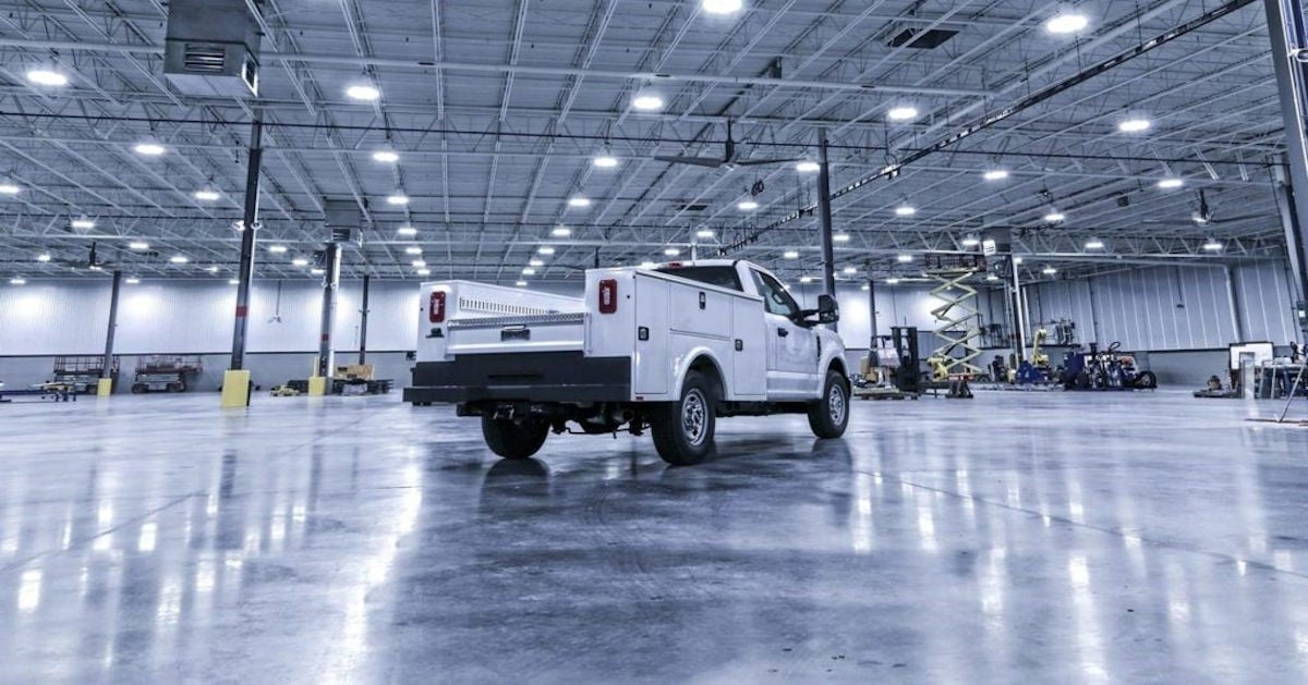 Truck with white service body in warehouse