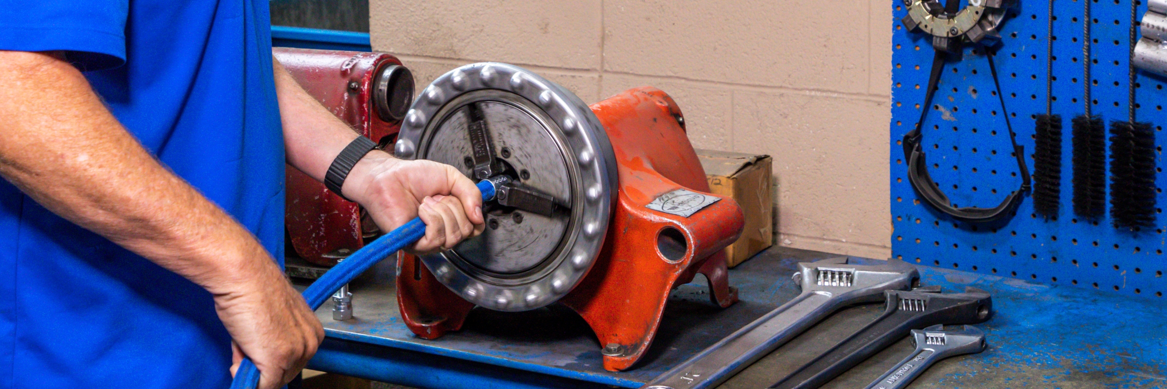 employee creating custom hose for truck