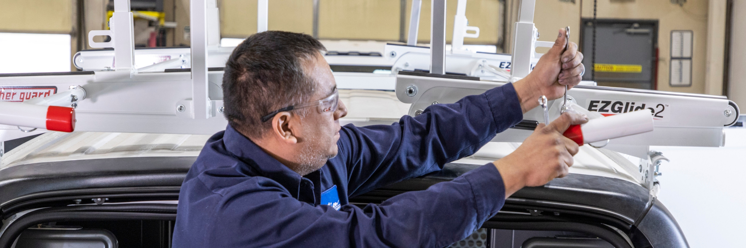 technician installing rack on cargo van